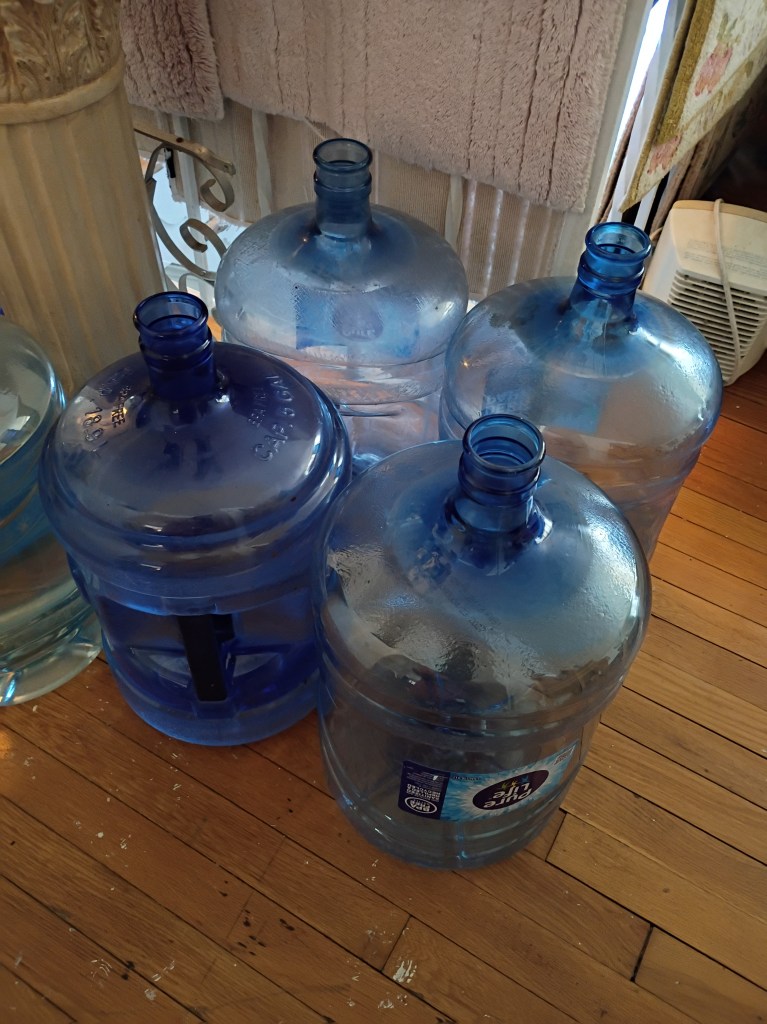 Photo of big water bottles on floor