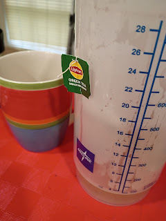 Photo of two cups one with green tea